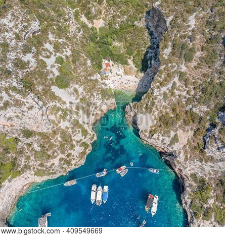 Aerial View Of Tourists Sunbath Swim At Stiniva Cove Beach Of Adriatic Sea On Vis Island In Croatia 