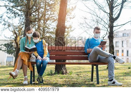 Concept picture of families torn apart by social distancing during corona crisis