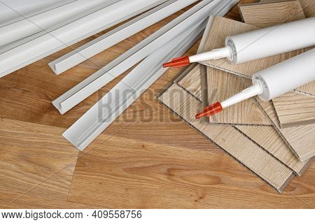 Set Of Items For Pvc Ceiling Indoor Works. Assembly Adhesive Bottles And Pvc Panels With Plastic Cor