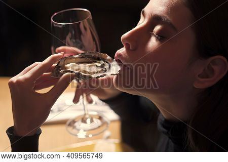 Portrait Of A Young Woman Having Lunch With Mussels And Wine. Seafood And Mediterranean Cuisine With
