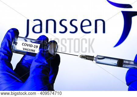 Madrid, Spain- February 23, 2021: Hand On Blue Surgery Glove Extracting Covid Vaccine From Vial With