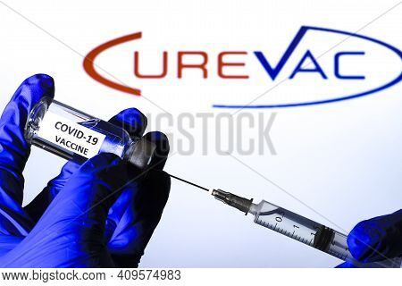 Madrid, Spain- February 23, 2021: Hand On Blue Surgery Glove Extracting Covid Vaccine From Vial With