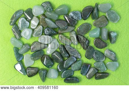 Macrophoto Of Mineral Rock Specimen - Tumbled Green Aventurine Gemstone On Green Background Partial 