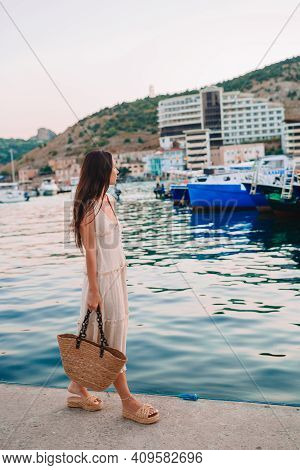 Young Beautiful Woman Walking On Dock Near The Boat