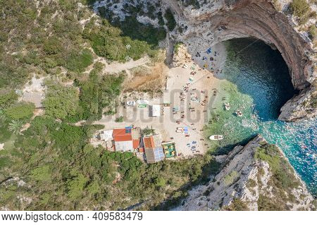 Aerial Overhead Drone Shot Of Tourists Swim Sunbath At Stiniva Beach On Vis Island In Croatia Summer