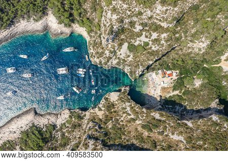 Aerial Overhead Drone Shot Of Yachts At Adriatic Sea Tourists At Stiniva Beach On Vis Island In Croa