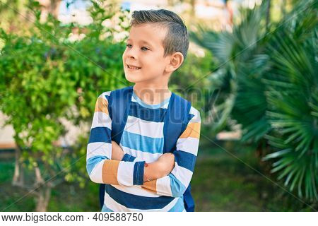 dorable caucasian student boy smiling happy standing at the park.