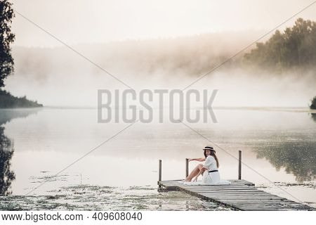 Tender Romanitc Sentimental Female Lady In The Morning On A Wooden Pier Near The Misty River In A Wh