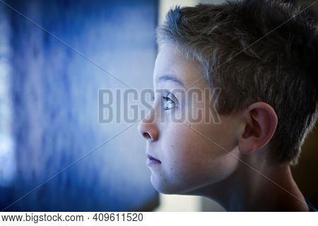 Boy watching television screen focus on eye