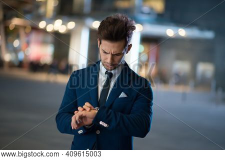 Young business man waiting for someone at night
