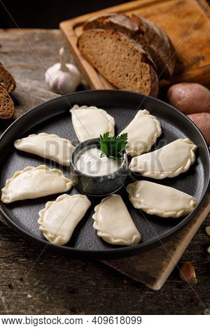 Appetizing Traditional Russian Dumplings, Hand-made With Potatoes. Still Life On A Wooden Board. Clo