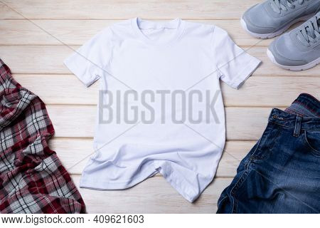 Men’s T-shirt Mockup With Indigo Jeans And Gray Running Shoes