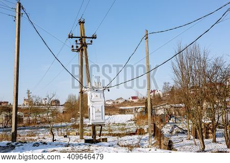 Electric Transformer Box On A Village Background. Electricity Supply To The Settlement. Power Distri