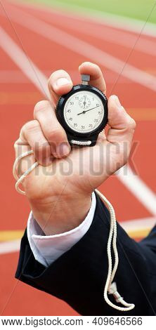 Time Is Running - Businessman In Stadium Holds Stopwatch In His Hand - Close-up