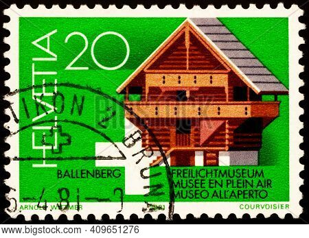 Moscow, Russia - February 22, 2021: Stamp Printed In Switzerland Shows Old Wooden Storage Shed Of Ki