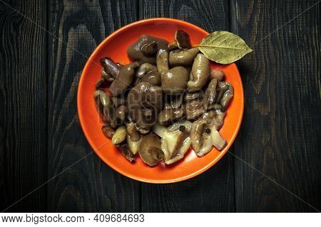 Suillus Luteus Or Boletus Luteus Mushrooms Marinated In A Plate With Spices And Bay Leaf On A Vintag