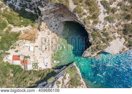 Aerial Overhead Drone Shot Of Tourists Swim Sunbath At Stiniva Beach On Vis Island In Croatia Summer