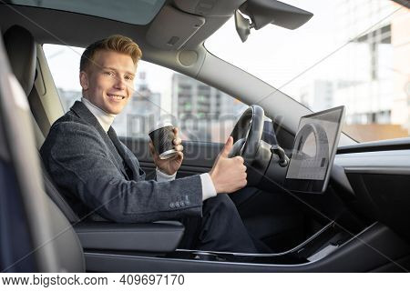 Test Driving Of New Generation Electro Vehicle With Self Driving System. Handsome Caucasian Man Sitt