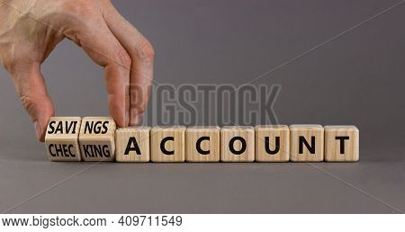 Savings Or Checking Account Symbol. Businessman Turns Wooden Cubes And Changes Words 'checking Accou