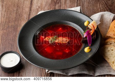 Ukrainian Traditional Borshch. Beetroot And Cabbage Soup With Meat Served With Sour Cream And Sliced