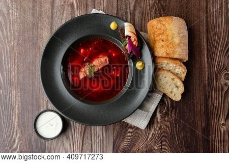 Ukrainian Traditional Borshch. Beetroot And Cabbage Soup With Meat Served With Sour Cream And Sliced