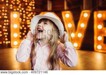 A Girl Wearing A Hat. Portrait. Smile. Decorated Letters Love