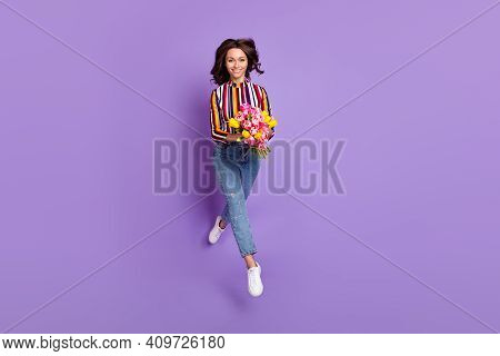 Full Length Body Size Photo Of Woman Jumping Running Holding Tulips Bunch Smiling Isolated Bright Pu