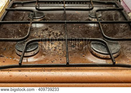 The Gas Stove Is Covered In Grease And Stains Of Dirt.unsanitary Conditions And Mess In The Kitchen.