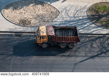 Truck With A Breakstone On A Road In The City During Road Construction Work.