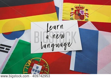 National Flags Of France, Porutgalia, Spain, Japan And Others And The Inscription Learn A New Langua