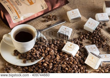 Tiraspol, Moldova - February 23, 2021: Cup Of Coffee, Grains Of Coffee And Barista Sweets On Sackclo