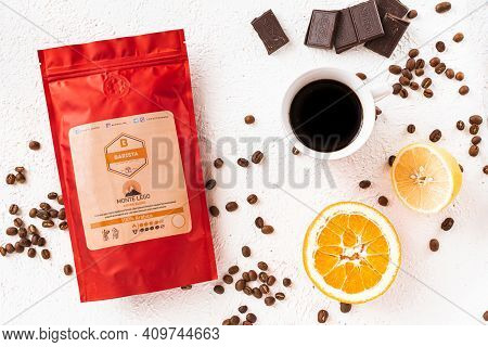 Tiraspol, Moldova - February 12, 2021: Red Coffee Bag With Degassing Valve, Cup Of Coffee, Coffee Be
