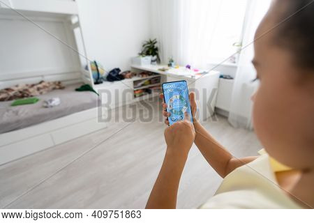 Shot Of Little Girl Using A Domotic System With Her Digital Tablet While Standing At Home.