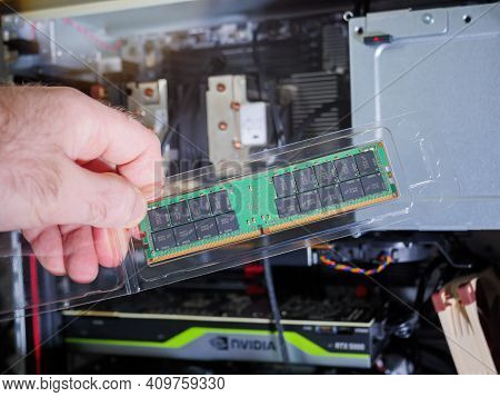 Paris, France - Feb 4, 2021: Pov Male Hand Holding Looking At The New Package Of Micron 64gb Ddr4 Rd