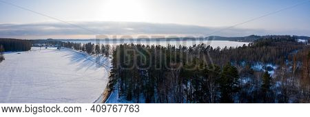 Beautiful Aerial View Of The Huge Frozen Lake In The Middle Of A Forest In Latvia. Frozen Ungurs Lak