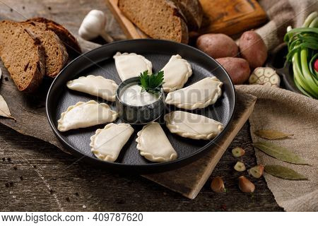 Appetizing Traditional Russian Dumplings, Hand-made With Potatoes. Still Life On A Wooden Board. Clo