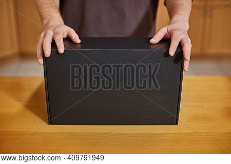 Shop assistant showing a blank black box of computer hardware equipment for buying, distributor office