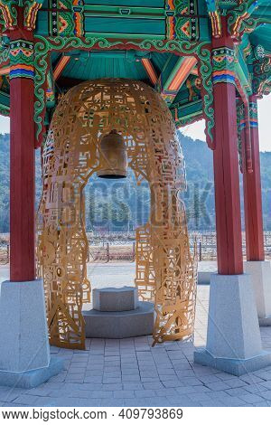 Chungbuk, South Korea;feb.21, 2021: Bronze Bell In Housing Sculpted From Metal Shaped In Korean Alph