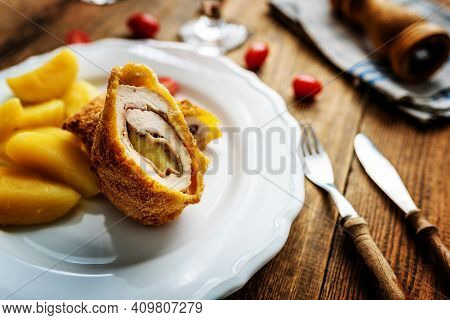 Traditional French Cuisine Chicken Roll Cordon Bleu Or Gordon Blue With Cheese, Ham And Potatoes