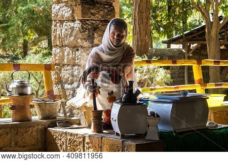 Yeha, Ethiopia - Feb 10, 2020: Young Woman In Traditional Clothing Is Preparing A Coffee Ceremony At