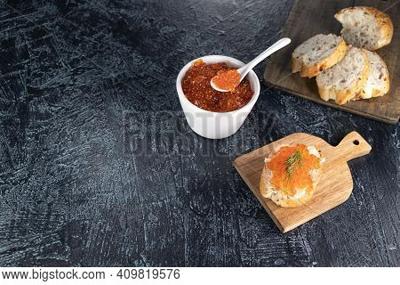 Recipe For Making An Appetizer With Red Caviar. Bagget, Red Caviar, Dill On A Black Background. Cook