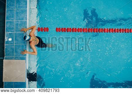 Young Woman Swimmer Swims At Swimming Pool Skirting