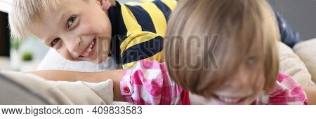 Boy And A Girl On The Couch Are Playing And Laughing. Interesting Outdoor Games For Children Concept