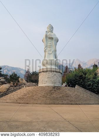 Qingdao, China - December 2017: Large White Marble Statue Of Guanyin Bodhisattva At The Entrance To 