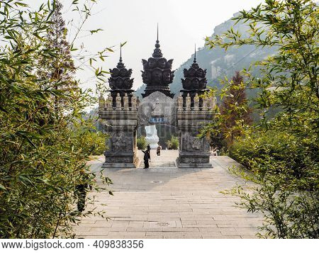 Qingdao, China - December 2017: White Carved Buddhist Archway 'huazang Shijie' As The Entrance To Th