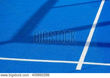 Bright Blue Tennis, Paddle Ball Or Pickleball Court Ground View With White Line In Shadows Outdoors 