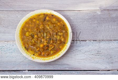 Ghugni Curry Or Curried Yellow Peas In A Plate Isolated On White Wooden Background With Copy Space