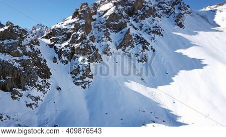 There Was An Avalanche In The Mountains. Top View From The Drone. Steep Slopes And Large Rocks. A Da