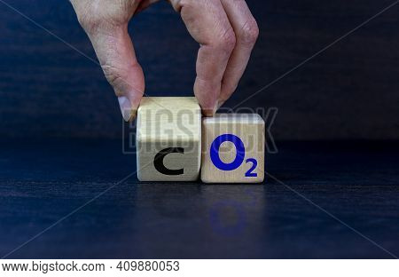 Co2 Or O2 Symbol. Businessman Turns The Wooden Cube And Changes Words 'co2, Carbon Dioxide' To 'o2, 