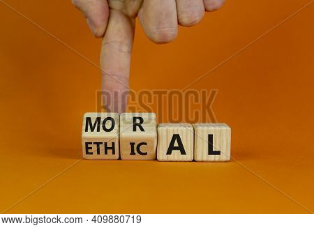 Ethical Or Moral Symbol. Businessman Turns Wooden Cubes And Changes The Word 'moral' To 'ethical' On
